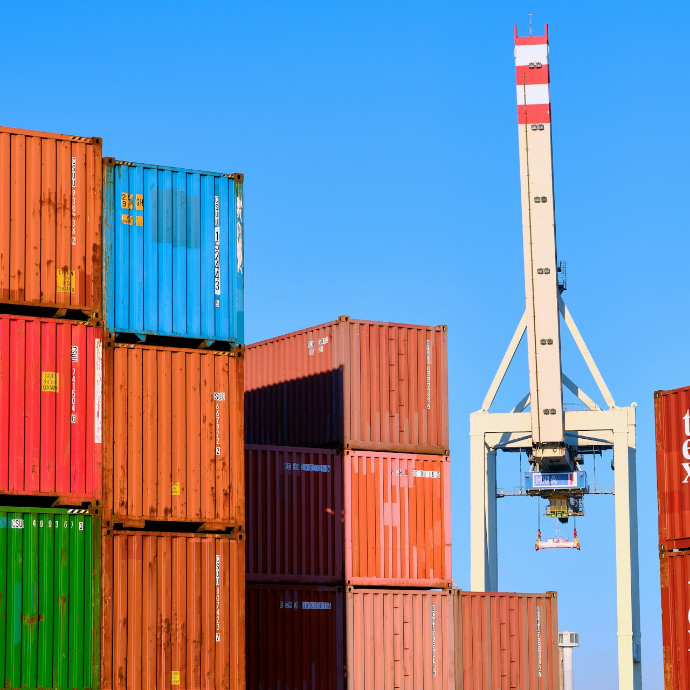 stack of cargo containers with white crane
